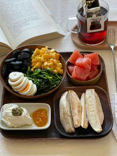 an open book is next to a plate of food