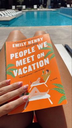 a woman sitting on the edge of a swimming pool reading a book about people we meet on vacation