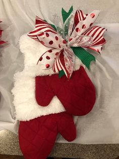 a christmas stocking hanging on the side of a bed with red and white stockings