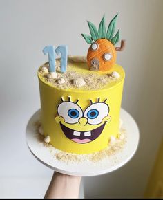 a spongebob themed birthday cake with pineapple and carrots on the top