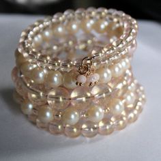 This Bracelet Is A Wrist Wrap Cuff Made From Five And A Half Strands Of Strong Shape Retaining Memory Wire (Tempered Stainless Steel Wire That Remembers Its Shape When You Expand It And Snaps Back To Its Original Form When You Release It). The Bracelet Self Adjusts To Your Movements. It Is 1 1/4 Inches Wide. It Is Made With Czech Glass Beads In Shades Of Champagne And Very Pale Pink, With Matching Glass Pearls. There Is A Pale Gold Silk Tassel On One End And A Multi Tiny Bead Dangle On The Other Pink Pearl Beaded Bracelets For Parties, Adjustable Cream Beaded Bracelets For Party, Champaign Pink, Jewelry Tutorials Free, Memory Wire Jewelry, Memory Wire Wrap Bracelets, Beaded Memory Wire Bracelets, Tiffany And Co Jewelry, Beaded Memory Wire