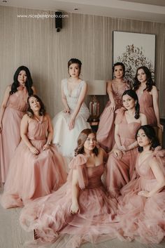 the bridesmaids are posing for a photo together in their pink wedding gowns