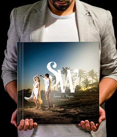 a man and woman holding up a book with the word save on it in front of them