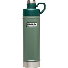 the stanley stainless steel water bottle is green and has a handle on it's side