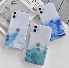 three iphone cases sitting on top of a table