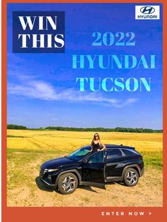 a woman sitting on the hood of a car in front of a field with blue sky and clouds