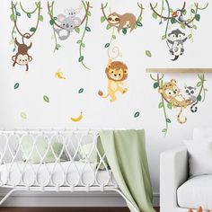 a baby's room with monkeys and other animals on the tree wall decals