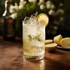 a glass filled with lemonade sitting on top of a table