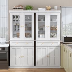 a kitchen with white cabinets and wooden floors