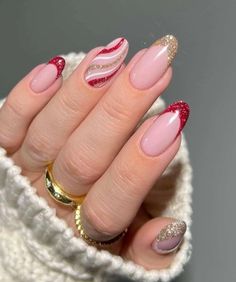 If you prefer a more understated look, minimalist Christmas nails with glitter can give you that subtle holiday sparkle. Minimalist designs focus on clean lines and simple accents, allowing the glitter to be the star of the show.  A popular minimalist idea is to paint your nails with a nude or light base color, then add a single glitter stripe across the middle or tip. This creates a classy, festive look without going overboard. Another option is to apply glitter to just one or two nails for an Santa Nails, Candy Cane Nails, Red Christmas Nails, Nagel Tips, Christmas Nails Acrylic