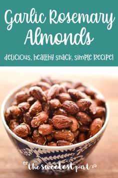 a blue and white bowl filled with almonds on top of a wooden table next to a