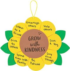 a sunflower with words on it that say grow with kindness