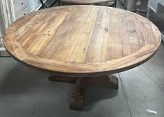 two wooden tables sitting next to each other on top of a cement floor in a room