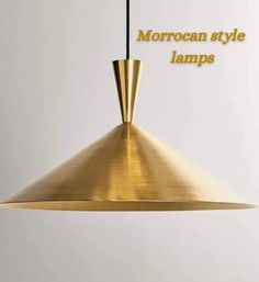 a gold colored lamp hanging from a ceiling with the words moroccan style lamps above it