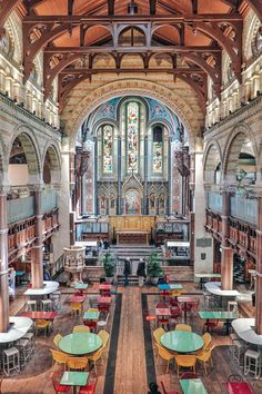 the interior of an old library with tables and chairs