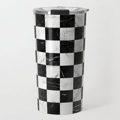 a black and white checkerboard pattern is on the side of this tumbler cup