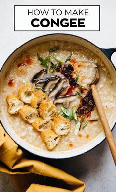 a bowl filled with rice and vegetables on top of a table next to a wooden spoon