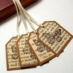 four tags with words on them hanging from string