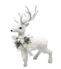 a white deer figurine with antlers and flowers on it's back