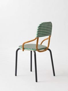 a green and black chair sitting on top of a white floor