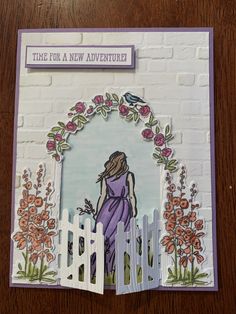 a card with an image of a woman standing in front of a white picket fence