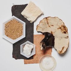 an assortment of food items including bread, rice and other ingredients on a white surface