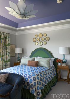 a bedroom with blue and green decor on the walls