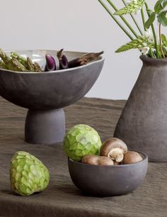 three bowls filled with vegetables on top of a table