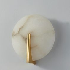 a white and gold object on a wall