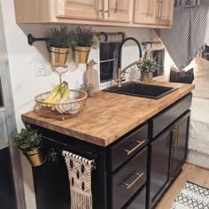 a kitchen area with sink, stove and cabinets