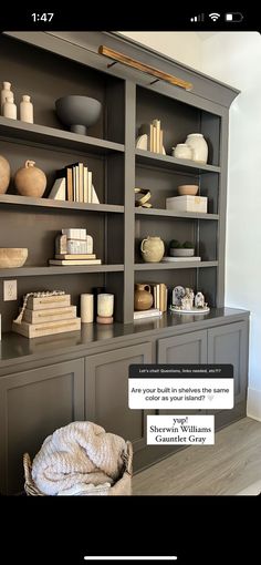 an open bookcase with books and vases on the top shelf in front of it