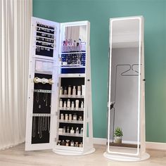 two white jewelry cabinets with mirrors on the wall and one is open to reveal an assortment of personal care items