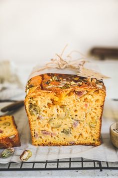 a loaf of bread sitting on top of a cooling rack next to other food items