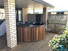 a hot tub sitting on top of a wooden deck