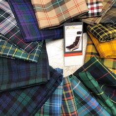 the tartan fabric is laid out on the floor and ready to be used as clothing