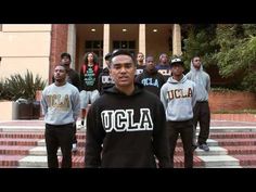 a group of young men standing in front of a building with the words ucla on it