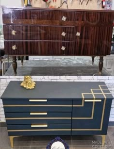 an old dresser has been painted black and gold