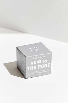 a cube shaped box with the words pure to the pore on it sitting on a white surface