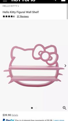 the hello kitty wall shelf is pink and has an image of a cat on it