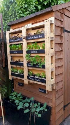 a garden shed with plants growing on the side and words written on it that read,