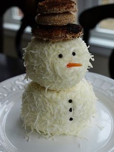 a snowman made out of rice krispy kreme on a white plate