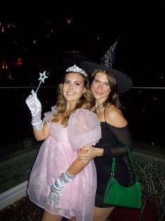 two women dressed up in costumes posing for the camera