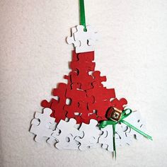 a drawing of a christmas tree made out of pieces of red paper and green scissors