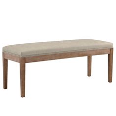 a wooden bench with a beige upholstered seat