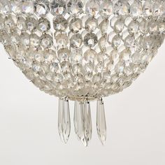 a chandelier hanging from the ceiling with crystal drops on it's sides