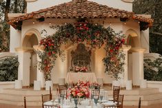 an outdoor wedding setup with flowers and greenery