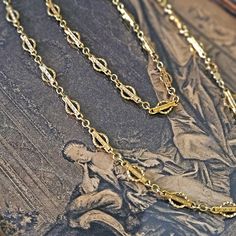 Long Victorian 14k Yellow Solid Gold Gothic Revival Geometric Antique Sautoir Necklace Chain 20.5 inches This sautoir antique 14k yellow gold Victorian chain is a rare and fabulous find. Gothic Revival geometric style, so popular in 1900s, each link with incised lines and dots in relief, modelled with fine detail - beading, scrolls, waves and curves. Weight: 15.9g Length: 20.5'' Width: 5.7mm Hallmarked: 14k, maker's mark This Necklace is in good condition, appears as new, just a a light antique patina. The Necklace has been polished, ready to wear.  !! Since we list antique and vintage items we try to make sure to identify any issues. However please go over the photos so you can assess any wear issues that would matter to you personally. Comes in the Gift Box and an Appraisal.   Retail Val Gothic Revival, Maker's Mark, Antique Victorian, Necklace Chain, Charm Necklaces, Estate Jewelry, Makers Mark, Chains Necklace, The Necklace