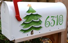 a white mailbox with a christmas tree painted on it