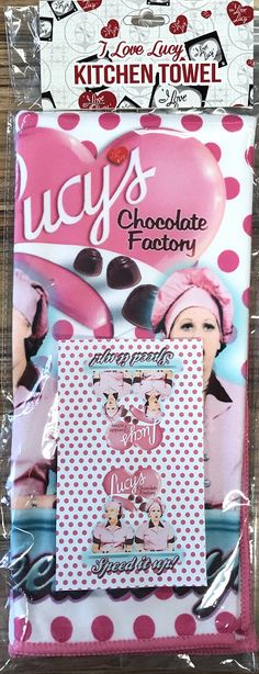 the package is wrapped in plastic and has pink polka dots on it, along with an image of a lady's chocolate factory