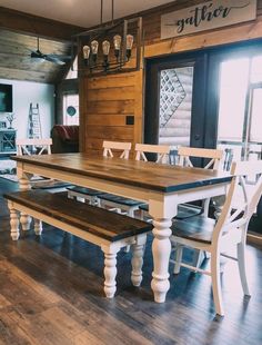 a dining room table with two benches in front of it